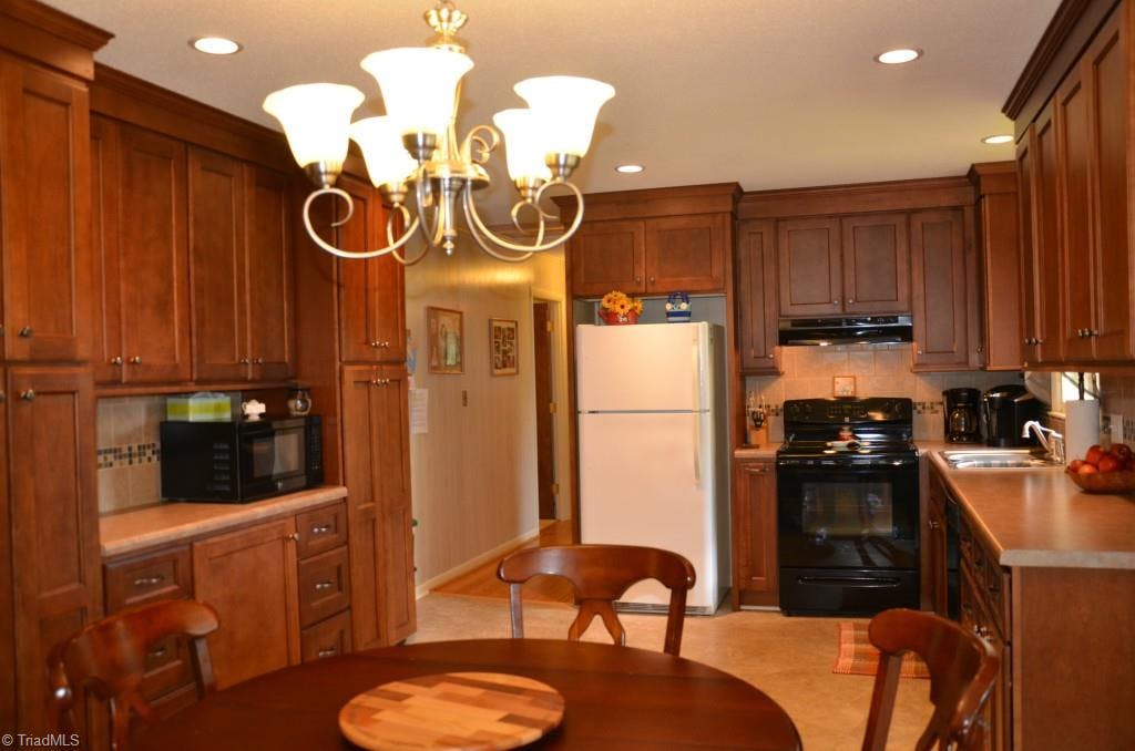 Gorgeous updated kitchen with new cabinets, recessed can lighting, and tile back-splash.