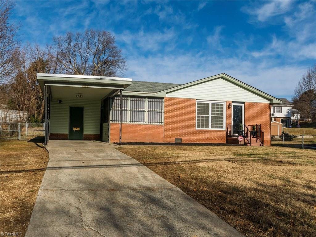 3 Bedroom, 2 Full Bath Brick and Vinyl home with generous front yard and flat fenced in back yard.  Behind attached carport is storage building.  Side door leads into mud room/laundry room.