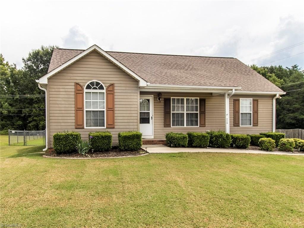 Welcome home to 306 Floyd Berrier Drive! This 3 Bed/2 Bath home features a split floor plan and master suite with a gorgeous, flat, and fully fenced backyard.  Serious curb appeal with the arched window, front porch, and perfect-for-this-home shutters.