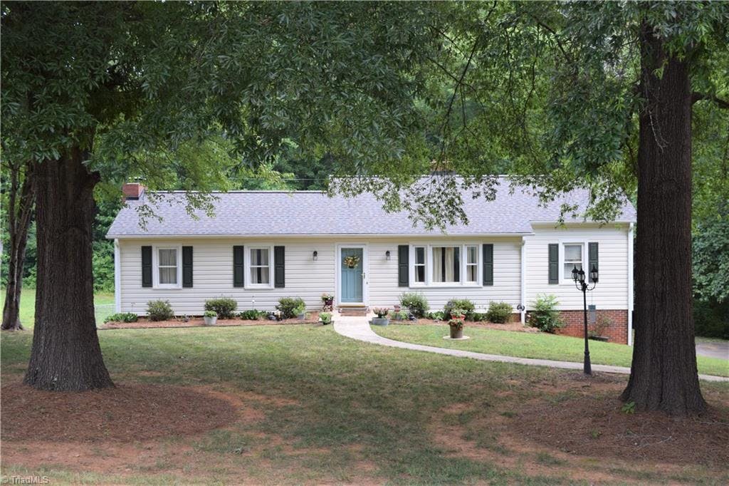 Welcome Home to 7595 Peggy Drive , ideally located close to the Yadkin River and Tanglewood Park with privacy galore!