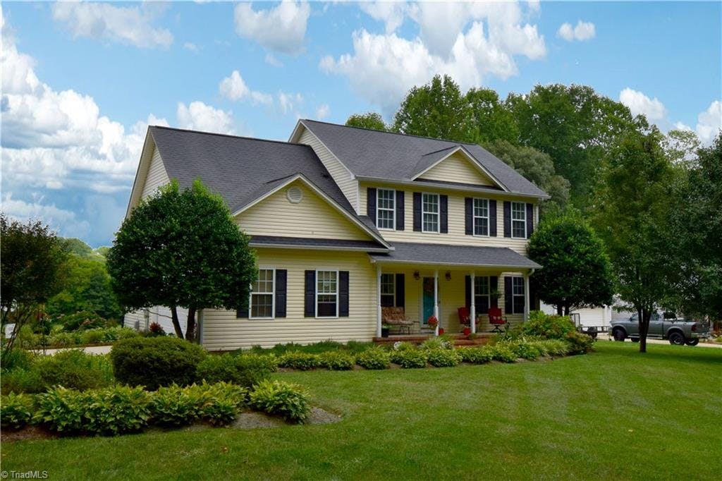 Beautfifully landscaped .69 of an acre lot perfectly frames this charming home with its inviting front porch.