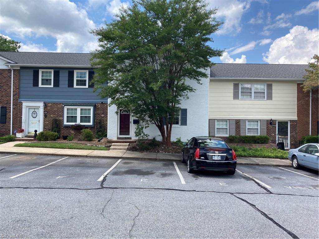 2 reserved parking spaces right in front of a Crepe Myrtle tree to provide beautiful shade.  Yours is the one in the center with the stately (yet modern) white brick front.  You're perfectly located 5 minutes from I-40, Hanes Mall & Forsyth Medical Center.