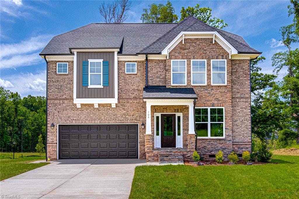 Gorgeous brick and stone front elevation with STONE front porch and staircase.