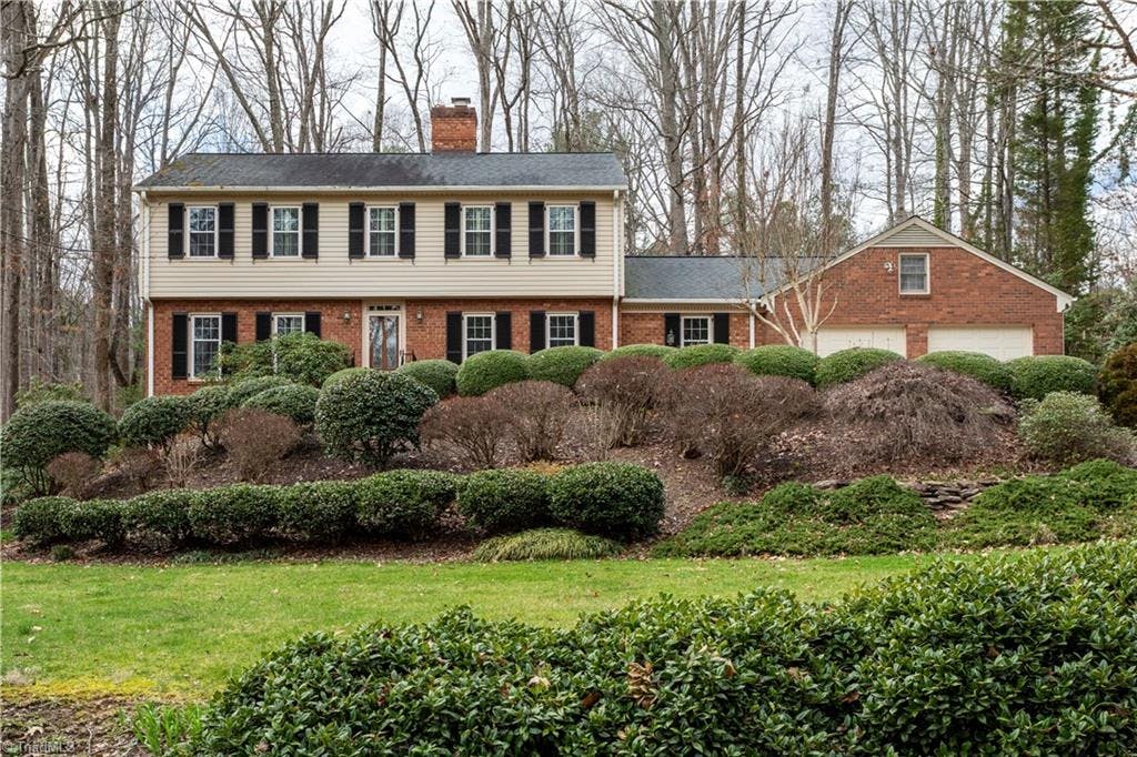 Proudly perched on a hill, this two story family home is nestled in beautiful Twin Acres, a lovely and established neighborhood within Lexington Country Club.
