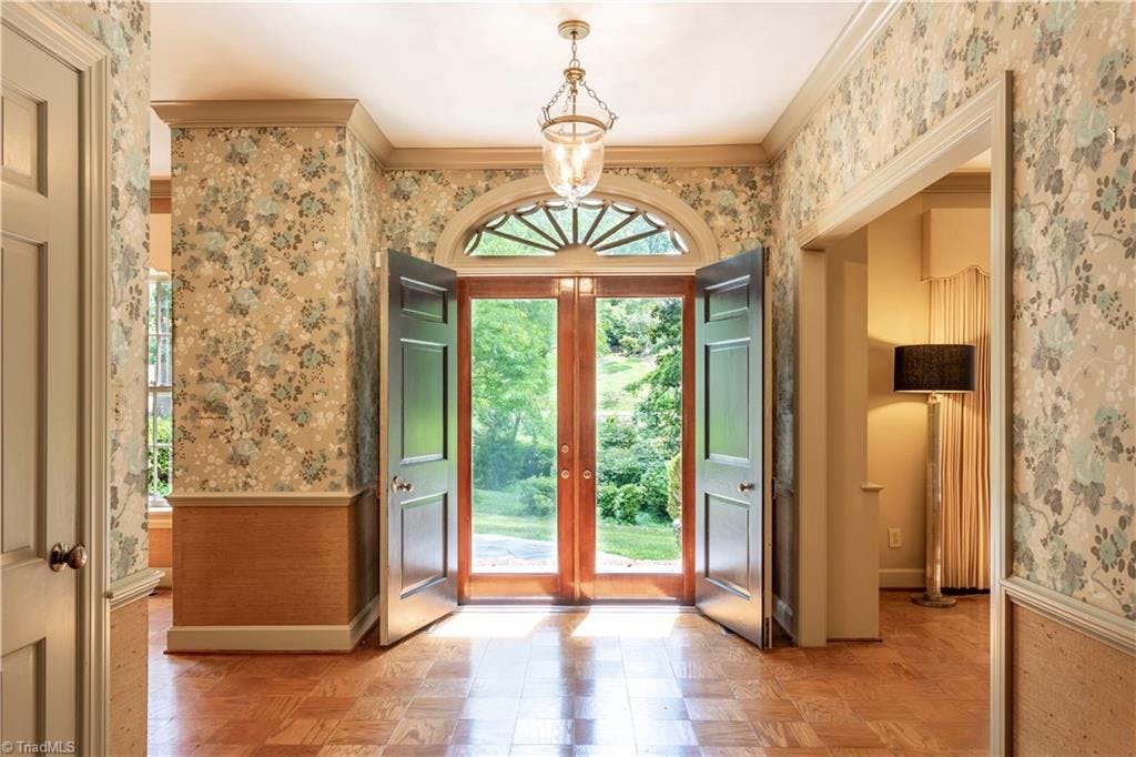 Allow the grand foyer to wrap you in the warmest Southern elegance! The double front doors set the stage, with formal living and dining rooms on either side.
