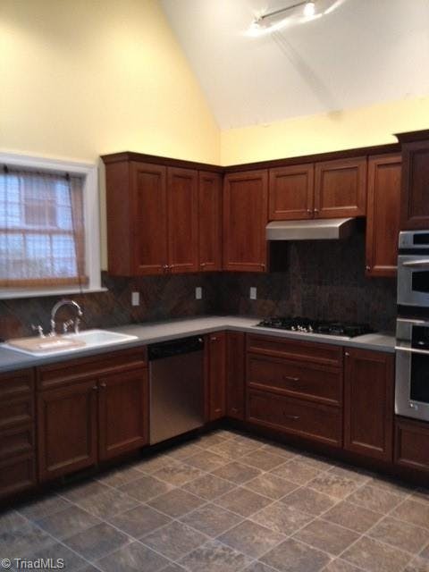 Large kitchen with vaulted ceilings, skylights, double doors to deck, pantry and eat in area.