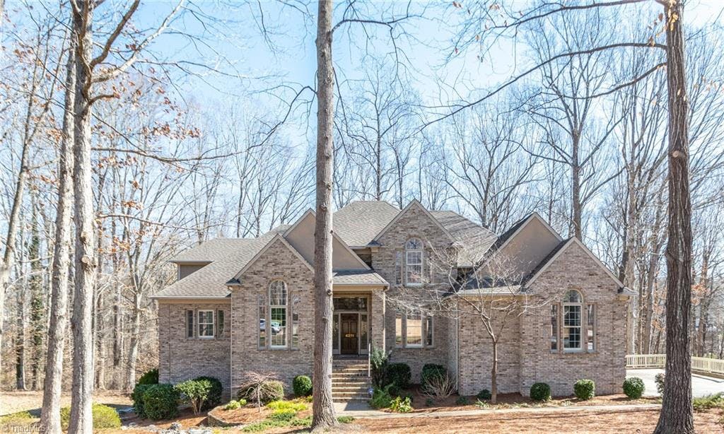 Located in the desirable Sedgefield XI community, this custom-built home is nestled on a .73 acre lot with professional landscaping