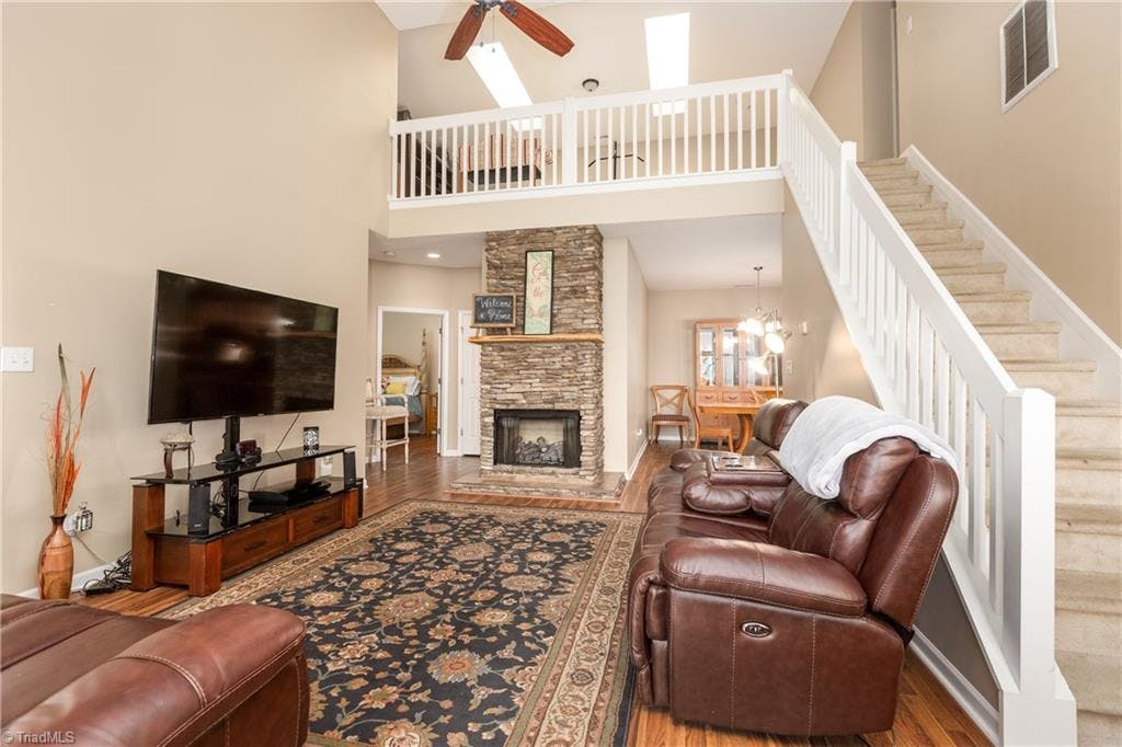 2-story Living Room with vaulted ceiling and gas fireplace looking up toward the loft area.