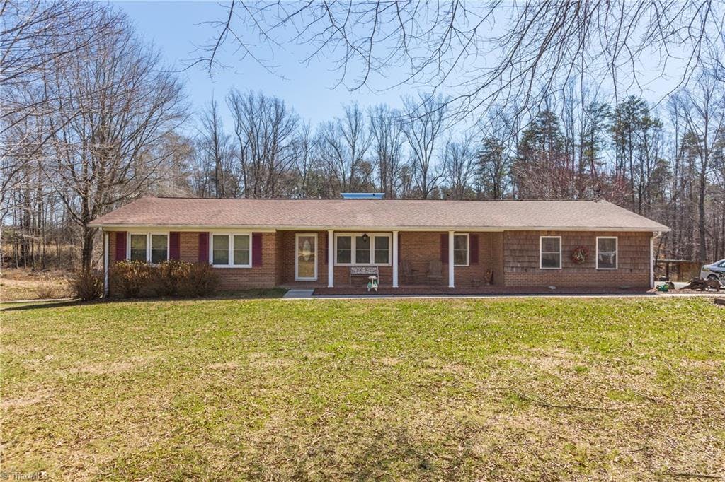 A beautiful Brick and wood shingle sided Ranch Home with easy access on a fairly level yard