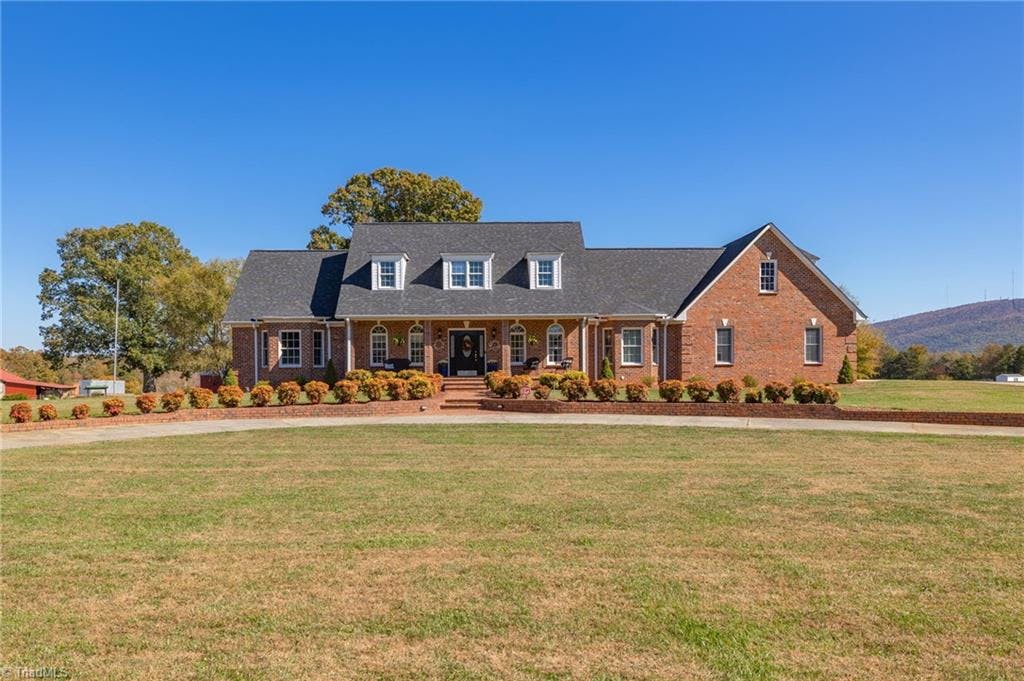 Gorgeous Custom built home with spectacular mountain views on 6 plus acres located in a lovely country setting just outside the town of Pilot Mountain (1.7 miles) with quick access to Hwy 52.
