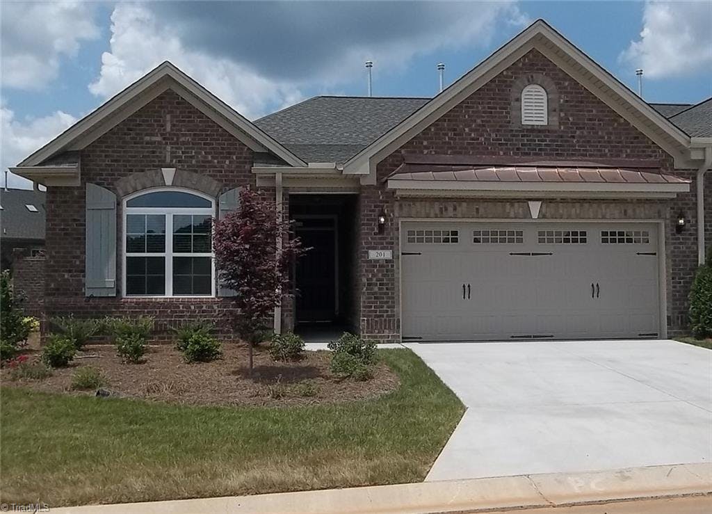 This home has a stately full brick exterior with decorative brick soldier courses and barrel vault copper roof over garage.  Another finished home pictured.  Actual home is still under construction.