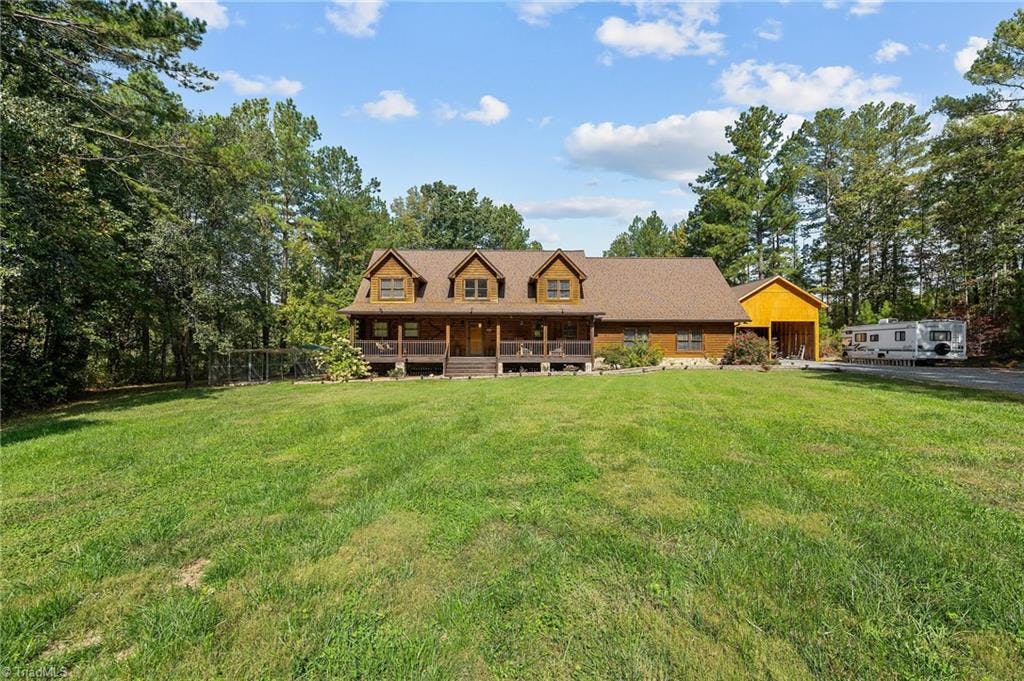Impressive private log cabin on 5.66 acres, with extra large RV and boat carport