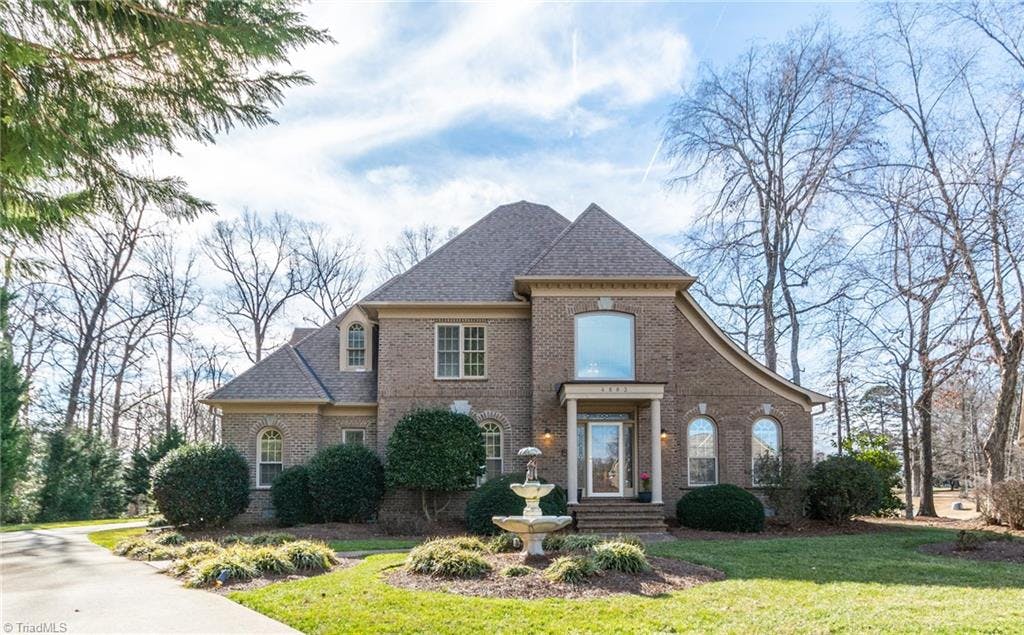 This custom-built home sits on a quiet cul-de-sac lot overlooking the 17th green of the Sedgefield Country Club golf course.
