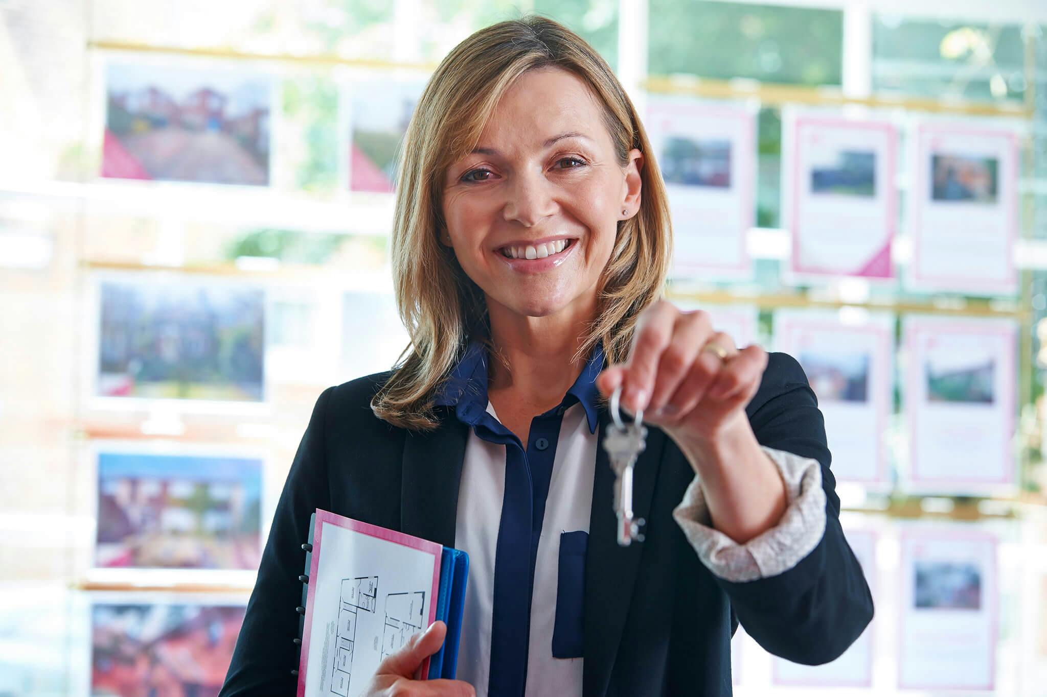 real estate agent holding keys to new home
